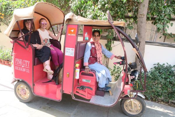 Co-founders Amy and Bee ride in the pink rickshaw through jaipur