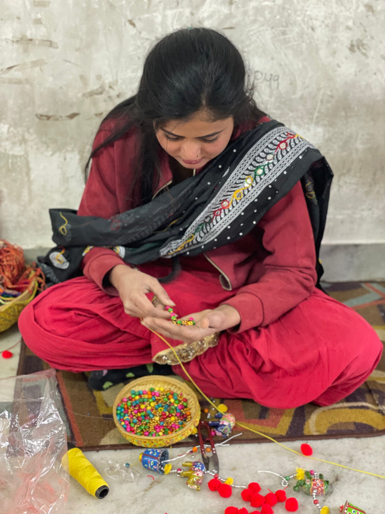 artisan stringing beads in Jaipur