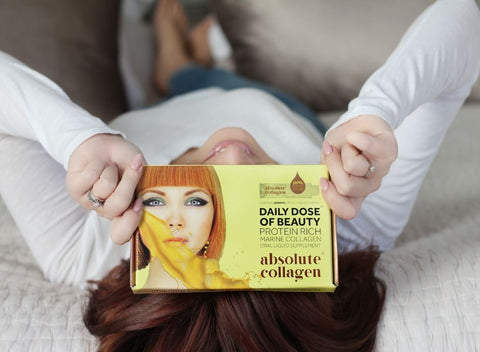 Woman holding box of Absolute Collagen 