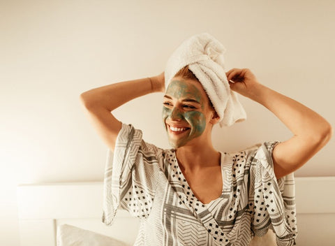 Woman with face mask and towel. Try pampering yourself to beat the January blues and blue monday - absolute collagen