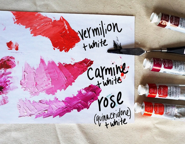 Tubes of Master’s oil paint laid out beside a palette. White has been mixed with three of the colours to make tints, vermilion, carmine and rose.