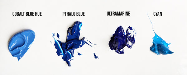 four blobs of blue acrylic paint, cobalt blue hue, pthalo blue, ultramarine and cyan