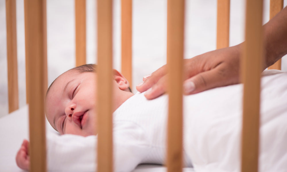 safest way for baby to sleep in bed