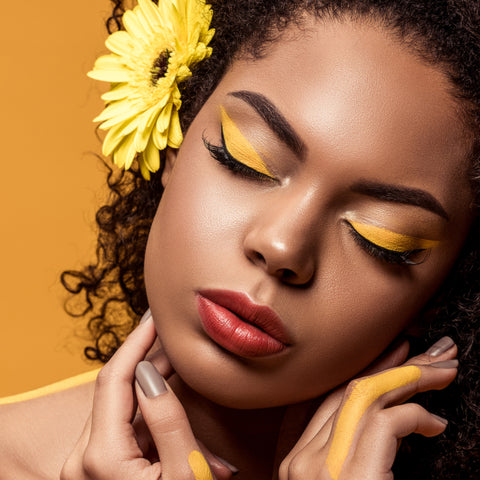 model with yellow eyeshadow and rustic red lipstick