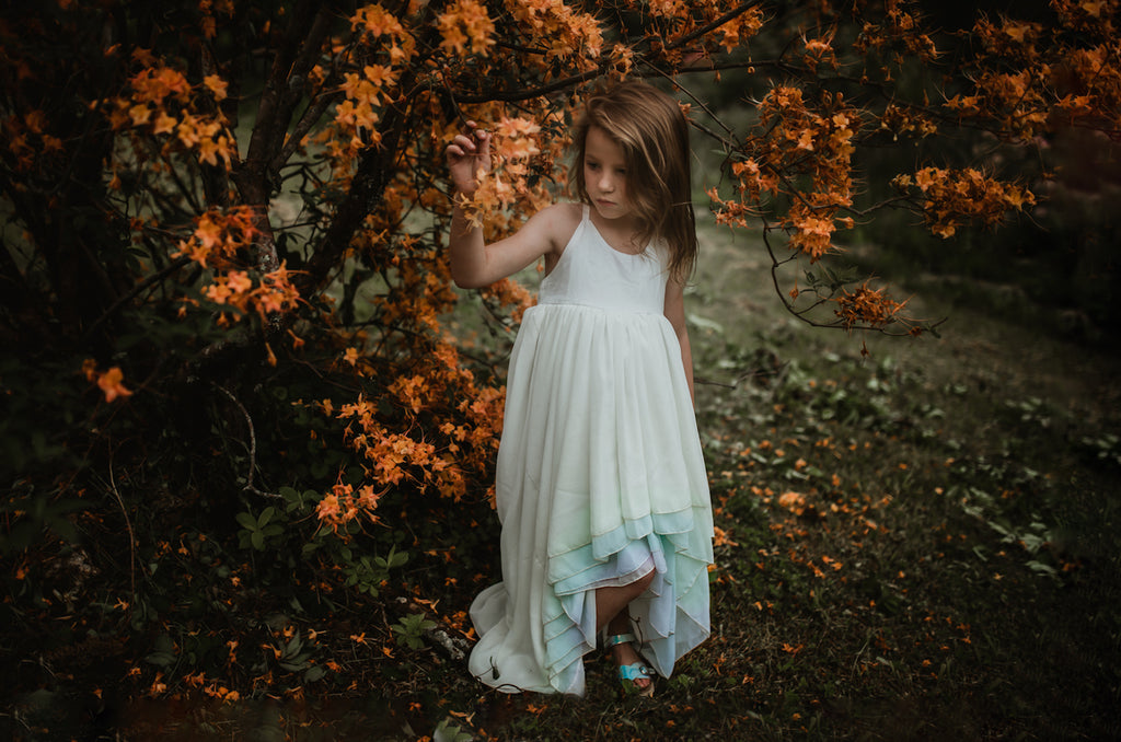 child wearing the sea glass Stella. pleiades designs and the traveling dress collective