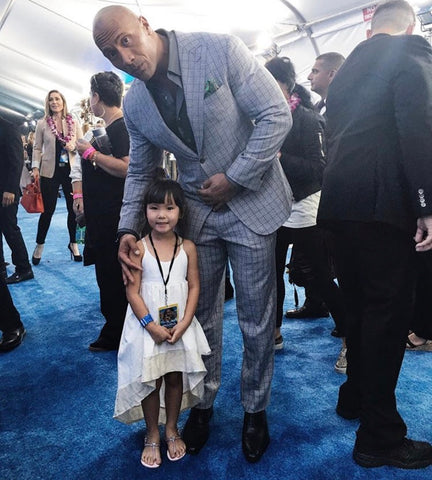 The Rock Dwane Johnson on the red carpet with his daughter who is wearing a windsong dress