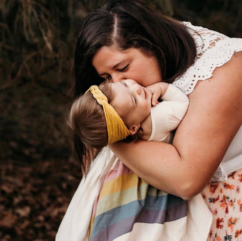 Mom with daughter in earth tone rainbow dress