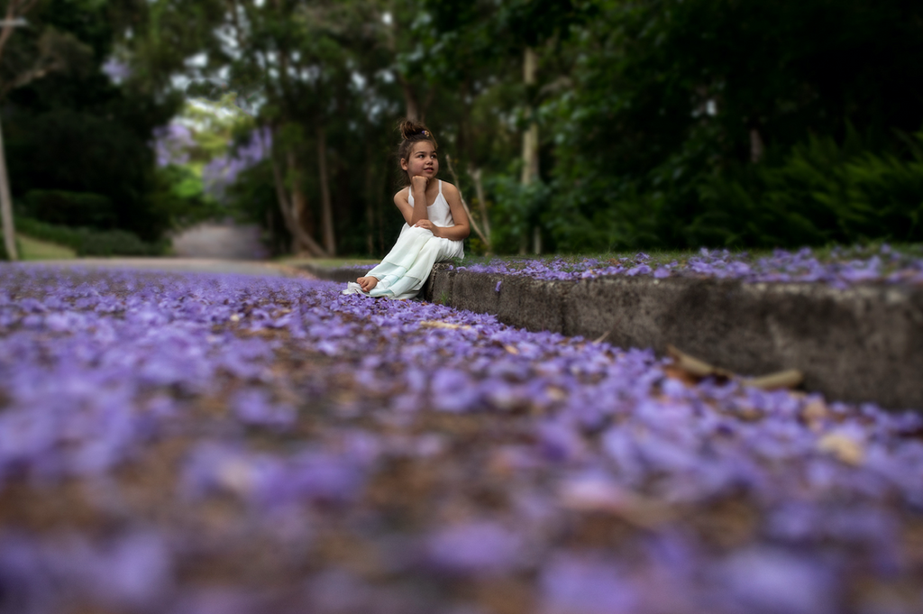 a child watching trees bloom while wearing the sea glass Stella dress. pleiades designs and the traveling dress collective