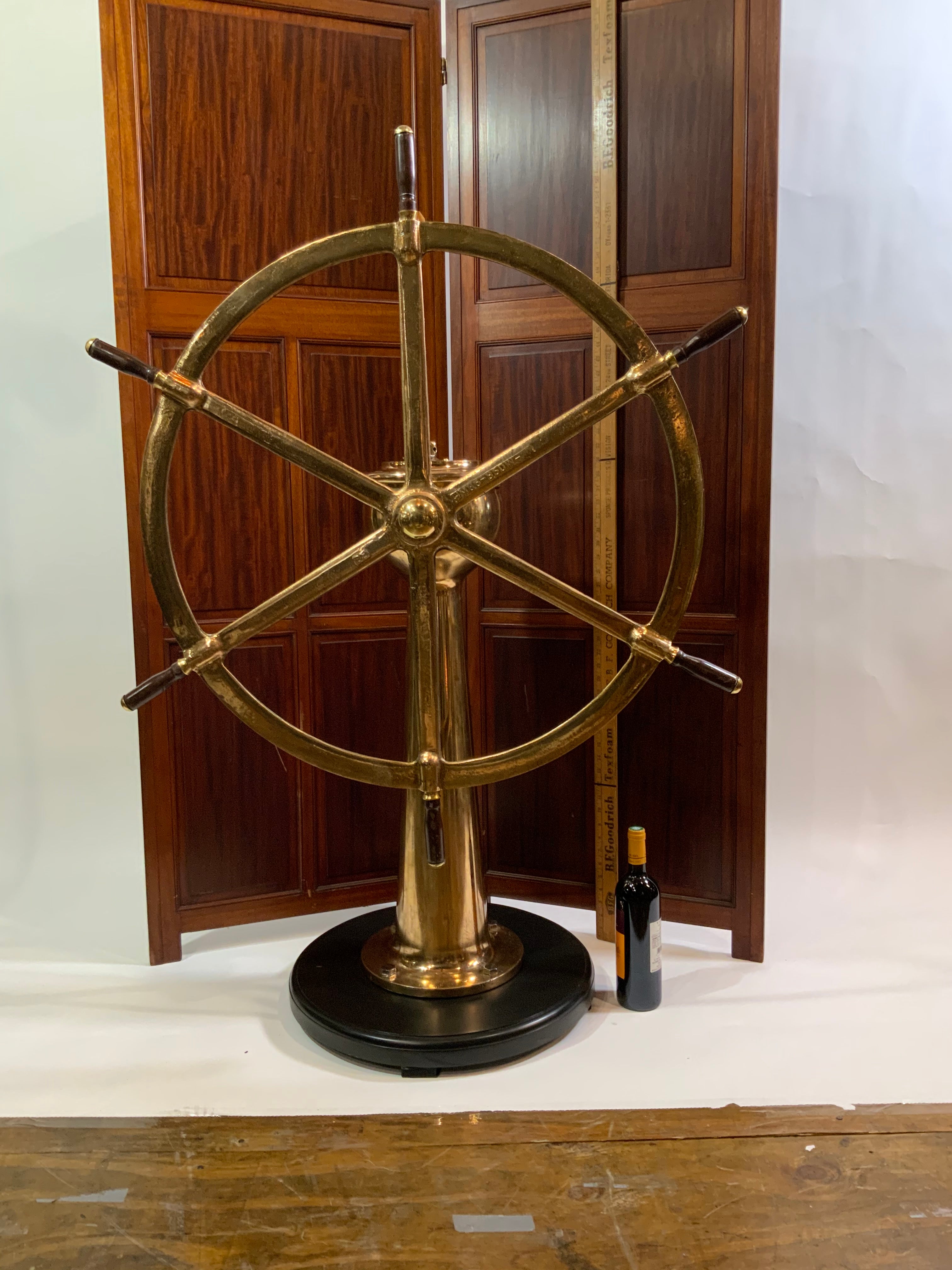 Solid Brass Ships Wheel Mounted Onto A Substantial Brass Pedestal