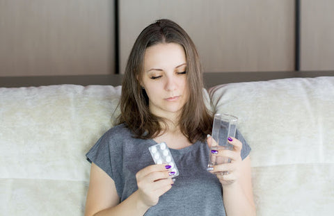 Woman taking medicine in bed weakened immune system
