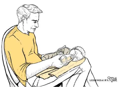 Dad feeding baby in side-lying position