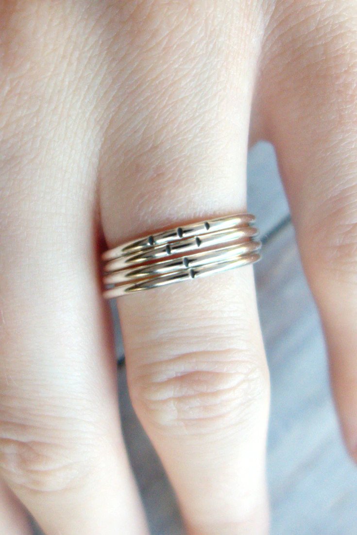 A model wearing silver stacking rings.