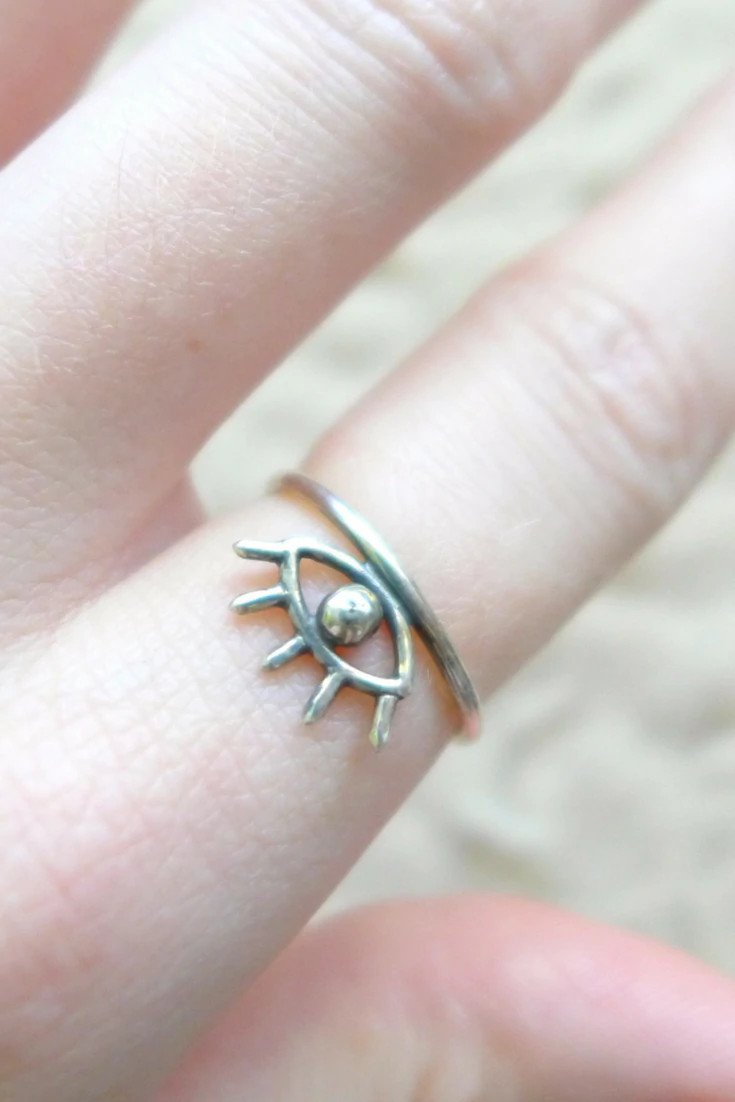 A woman wearing a silver evil eye ring.