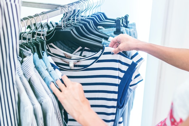 Person looking at a blue and white t-shirt