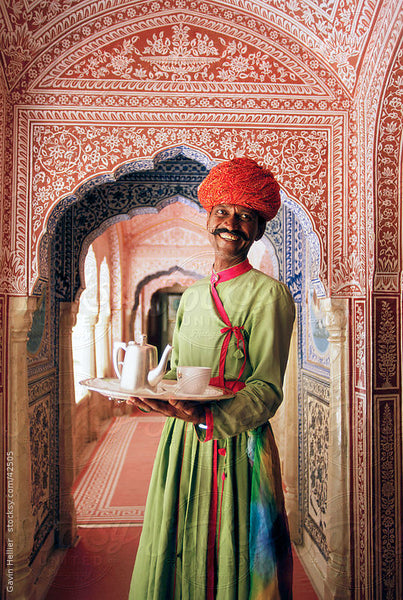 Indian man holding a tray of tea