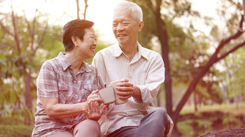 older asian couple enjoying a cup of tea