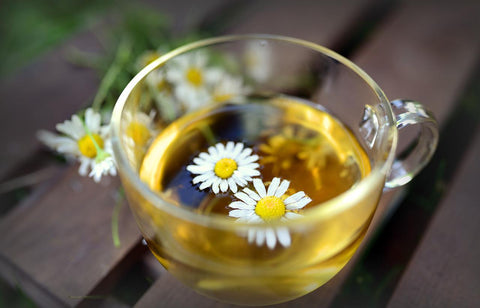 Chamomile tea in a glass teacup