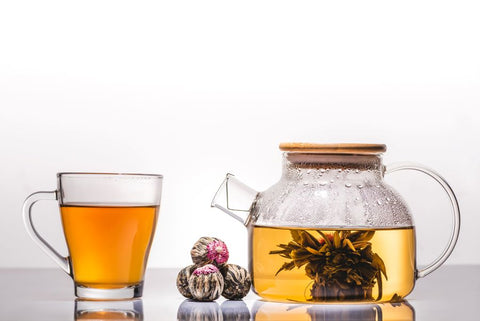 Flowering tea in teapot and glass