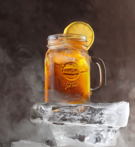 ice tea with orange and a block of ice