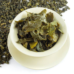 Oolong tea, showing the long, infused tealeaves in a teacup