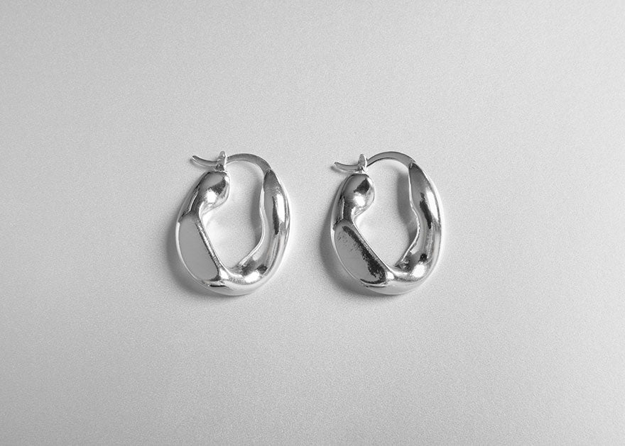 A pair of oddly shaped silver earrings