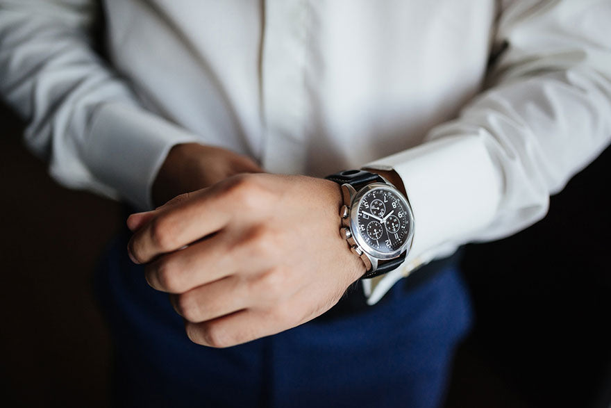 A stainless steel luxury watch on a man’s wrist