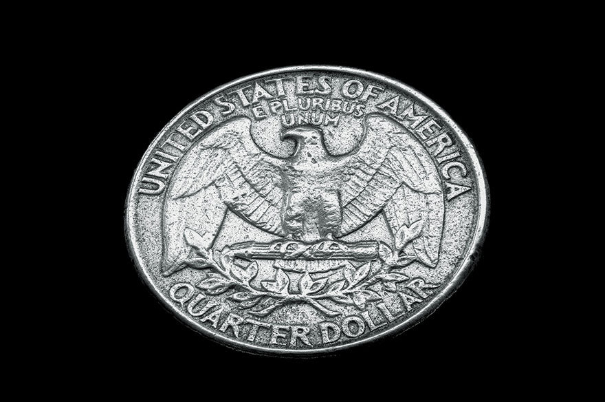 An antique United States silver quarter dollar.