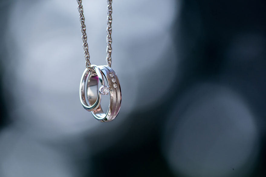 Two silver rings on a necklace