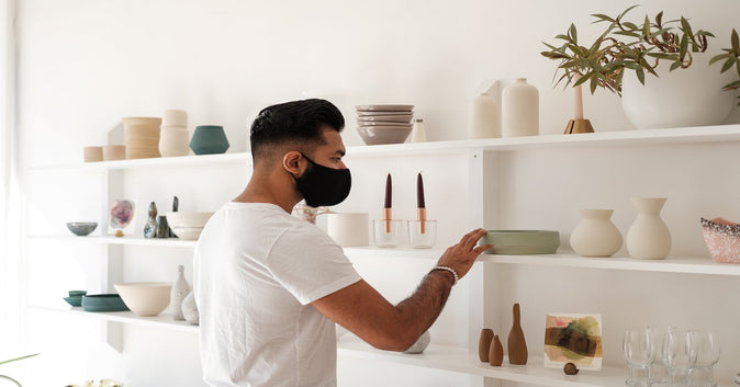 a guy fixing store shelves representing visual merchandising