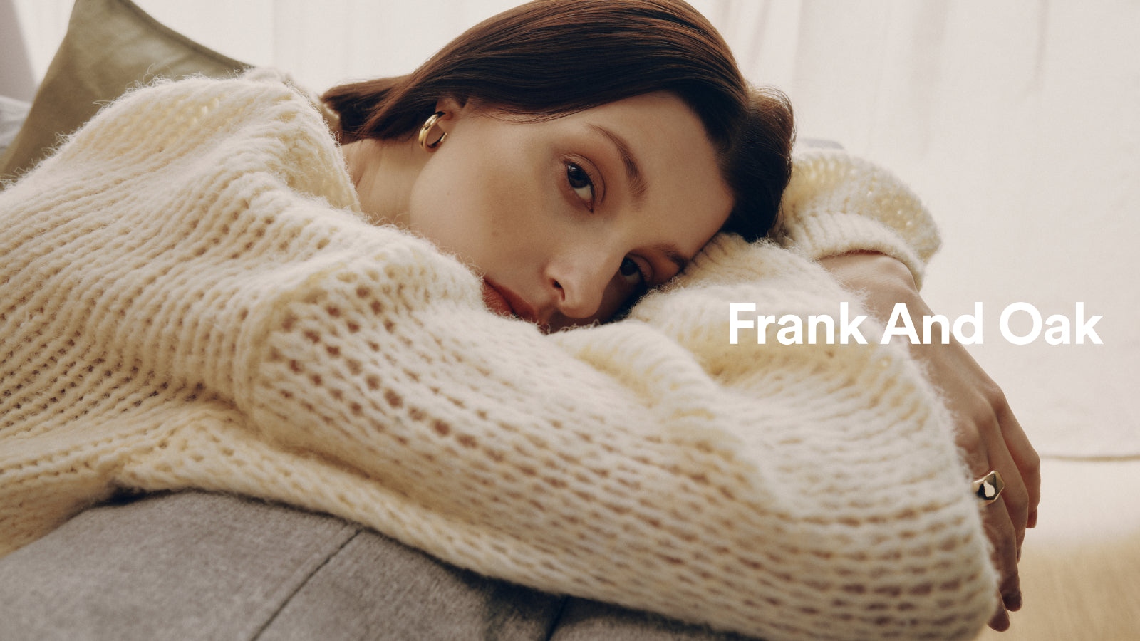 image of woman laying on couch with words Frank And Oak
