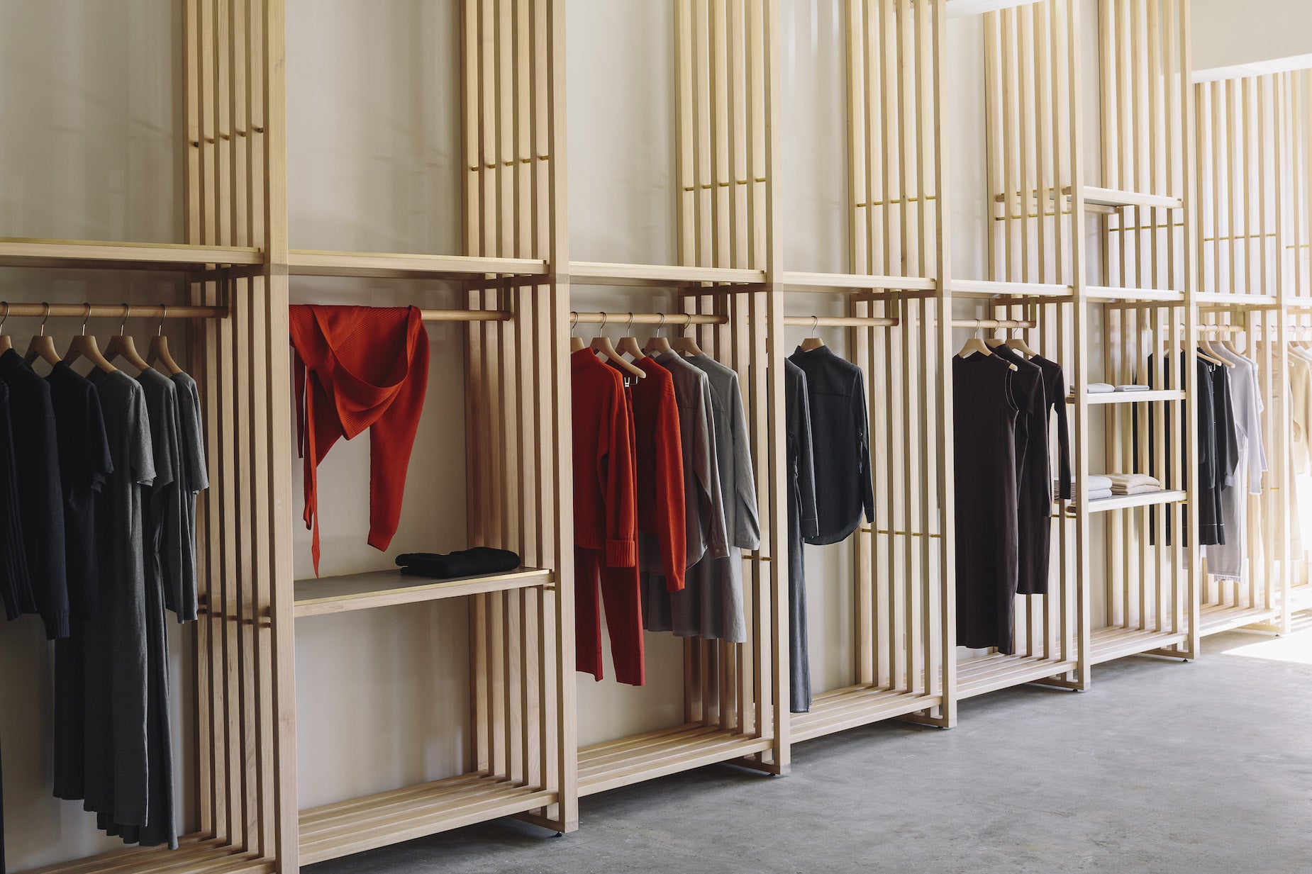 Navy, grey, and red clothes on display at Kowtow's retail store in Wellington, Australia.