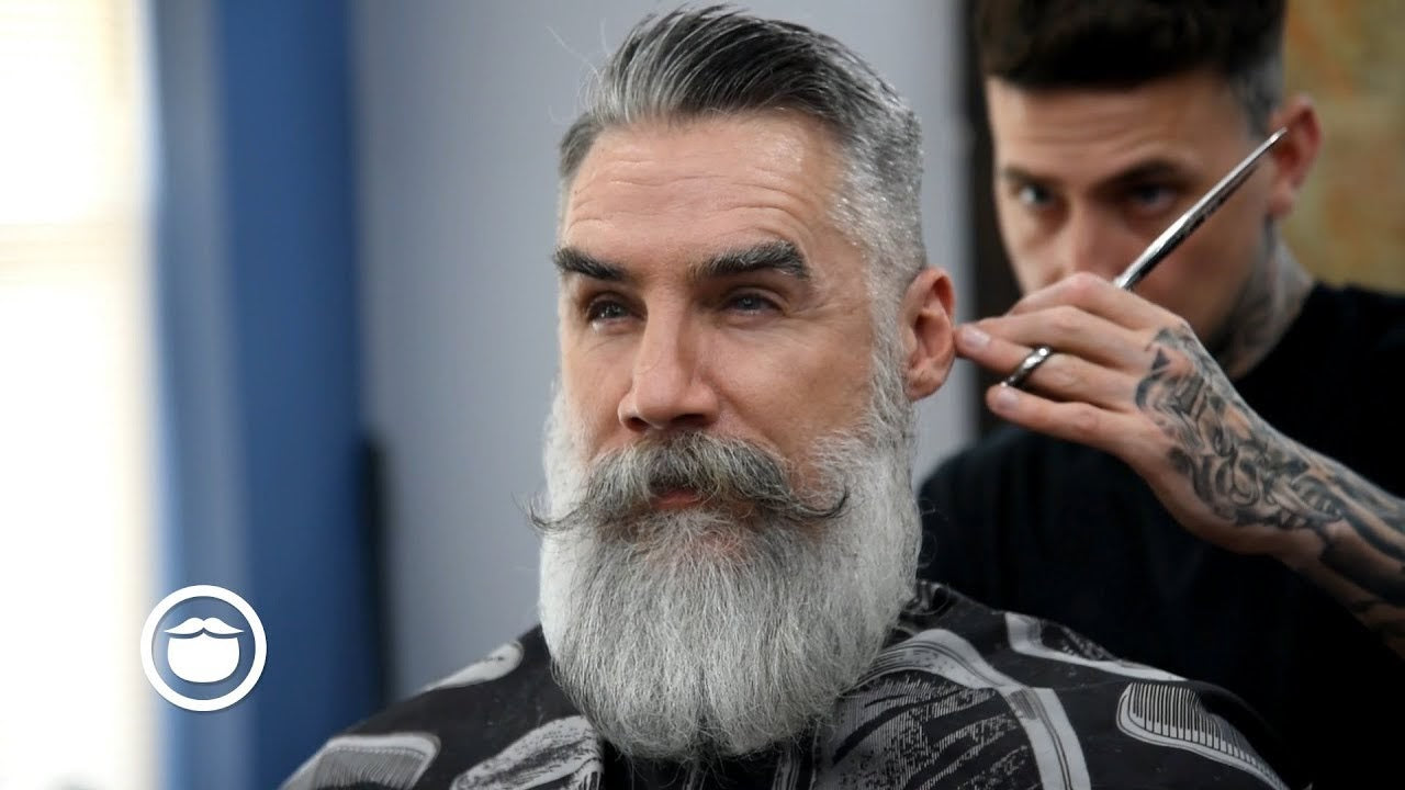 Man with a beard getting a trim