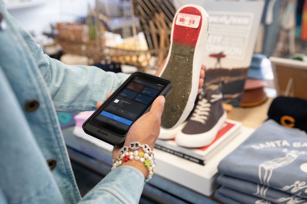 Store clerk using Shopify POS Go's built-in barcode scanner 