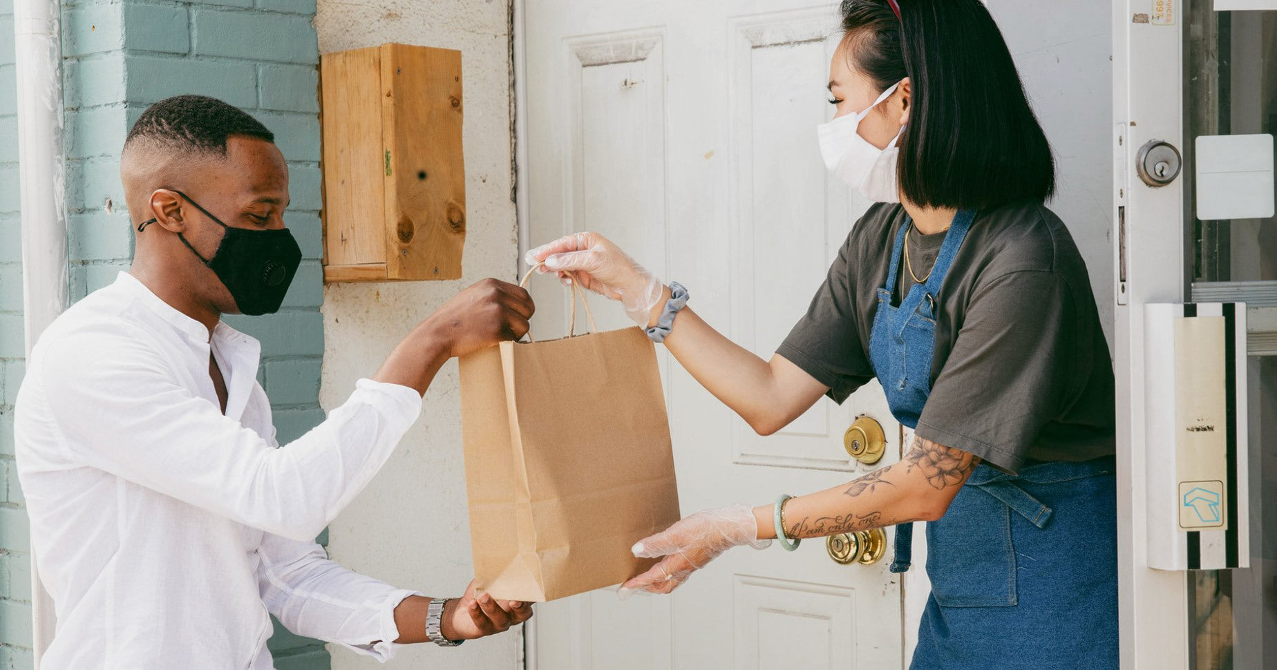 shop owner handing customer local pickup order