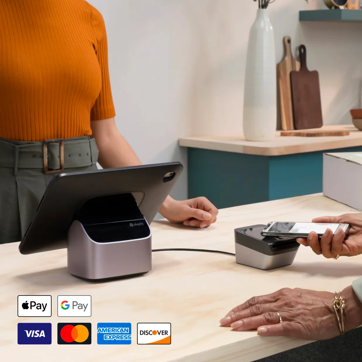 A customer paying at a cash register by tapping their phone.