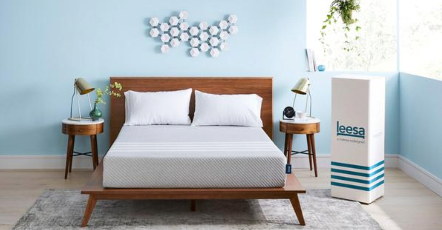 Pale-blue bedroom with wooden bed and Leesa mattress