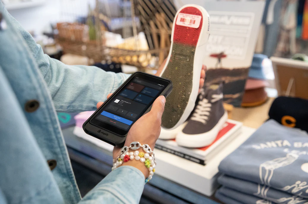 A retailer scans a product with Shopify POS Go