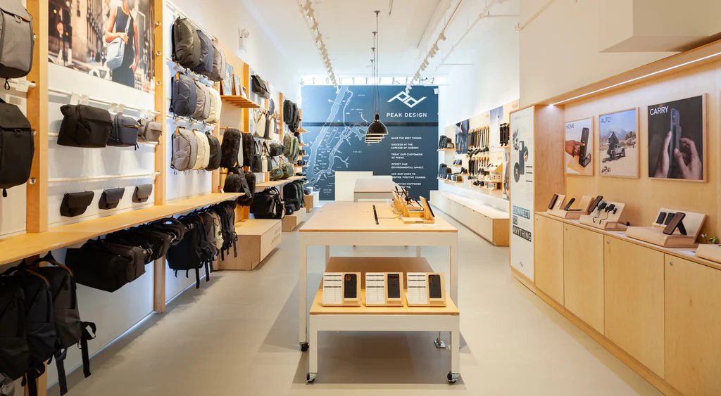Peak Design's storefront with wall-mounted racks to vertically display photography gear.