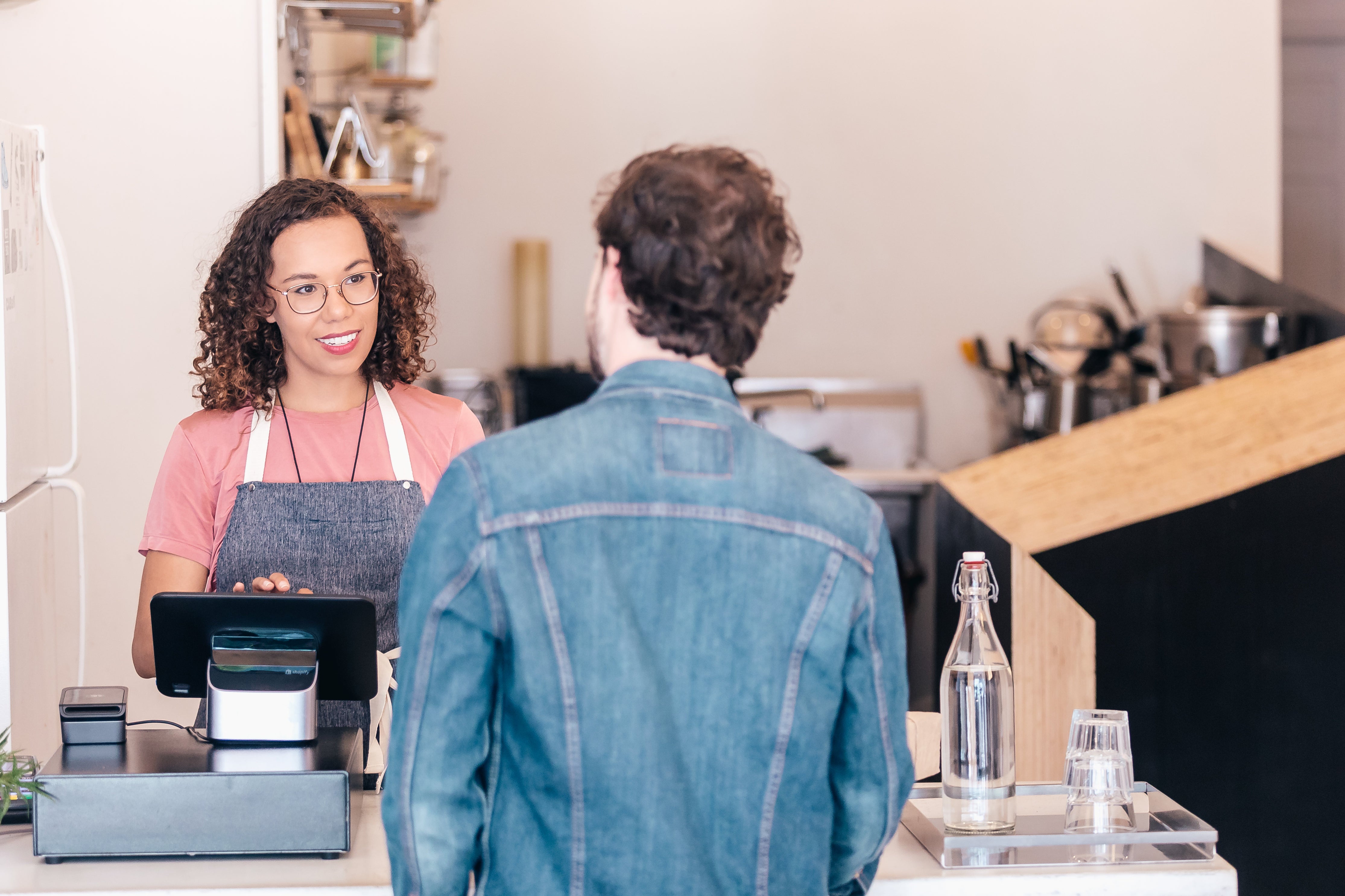 Woman and man at retail checkout counter 