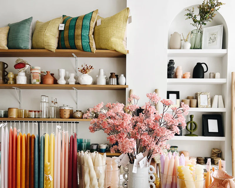 Home goods retailer Leif arranges complementary items—like candles, vases, and flowers—together.