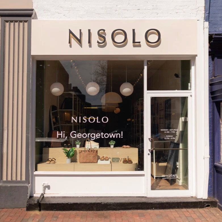 Nisolo's Georgetown store front and window display.