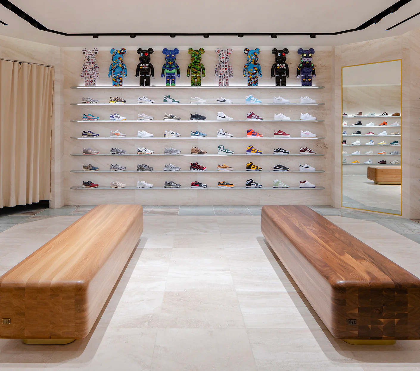 Streetwear store Kith spotlights shoes like works of art on a luxury showroom wall.