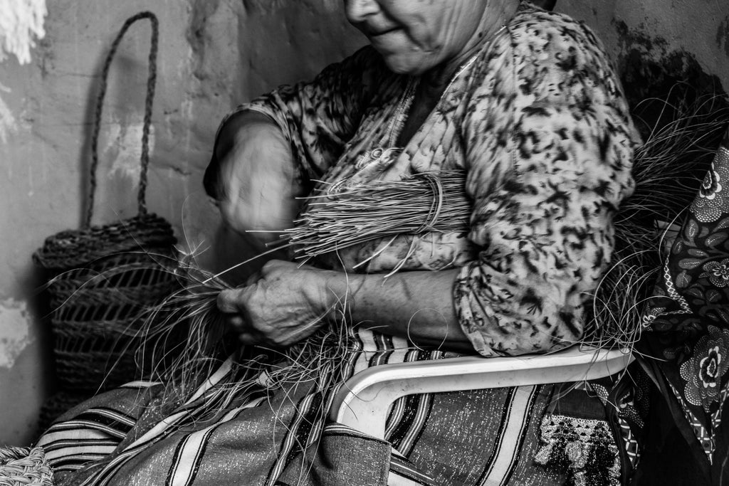 Woman with reeds for basket making