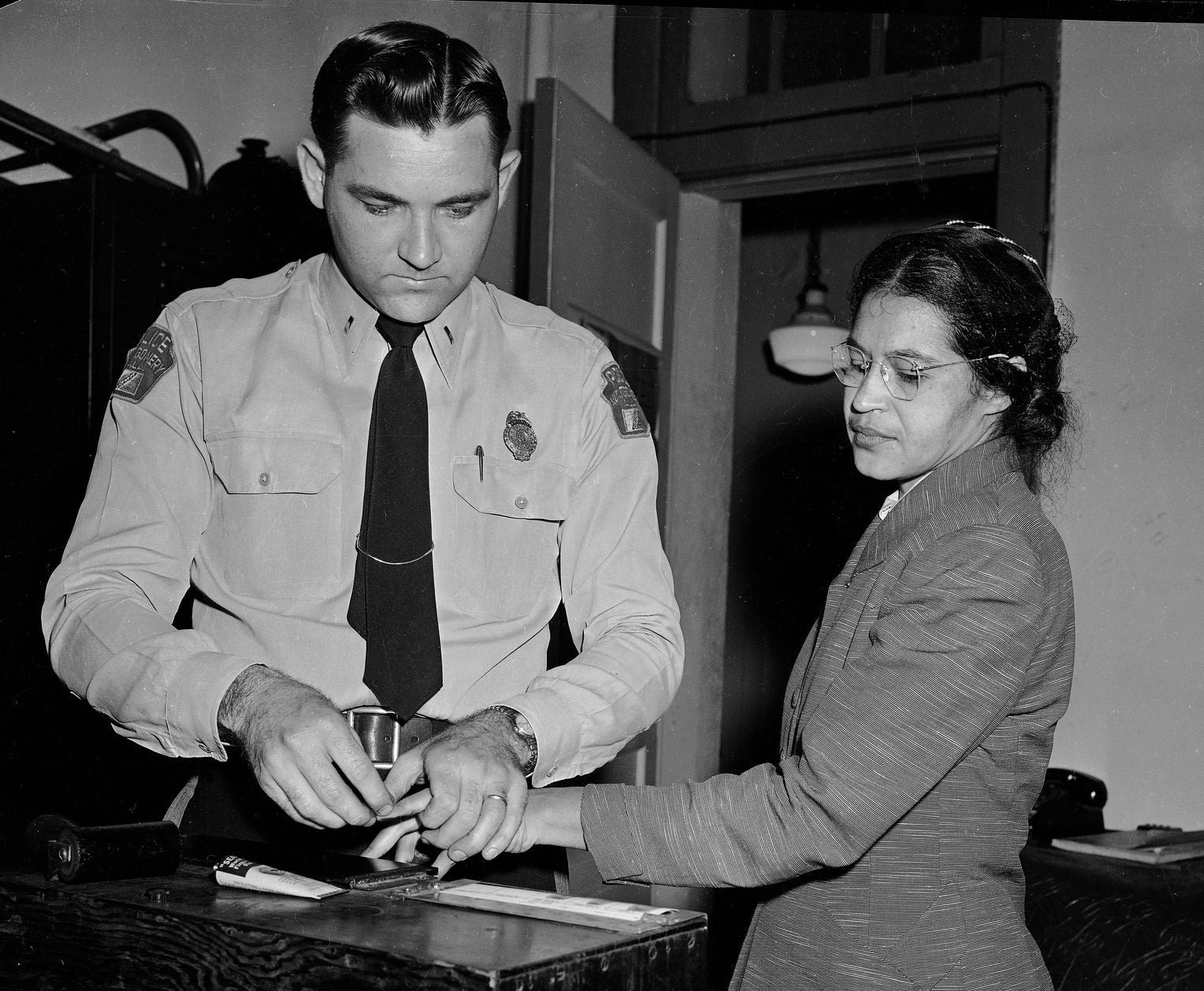 rosa parks is fingerprinted in december 1955 after her arrest. image courtesy of the library of congress.