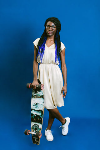 Maacah Davis poses with her skateboard for basic. Black HERstory.