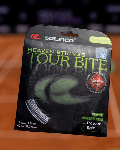 Solinco Tour Bite String pack on a clay court background
