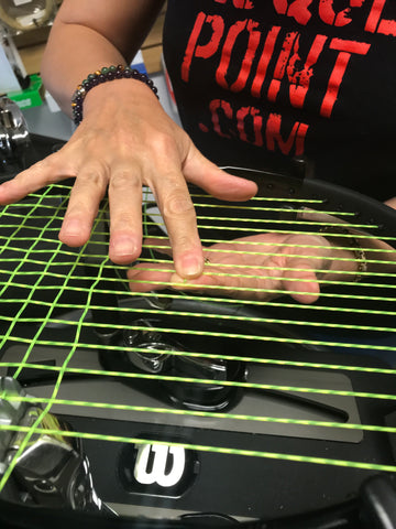 Restringing a tennis racket with synthetic gut at Racquet Point