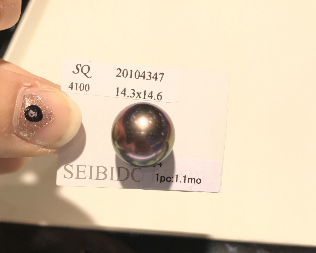 A single, large Tahitian pearl with intense color