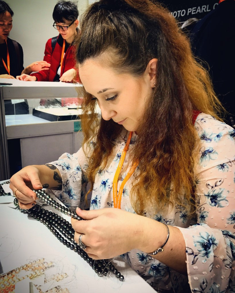 Examining strands of Tahitian pearls