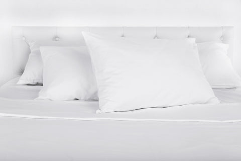 clean pillows neatly placed on a bed